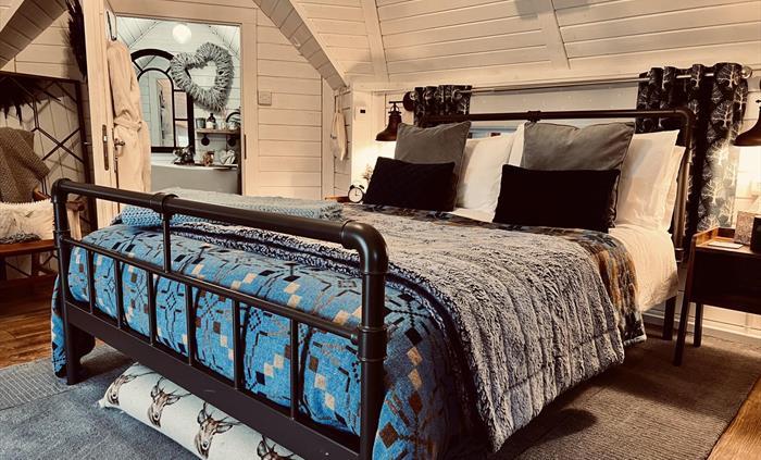 Our comfortable double bed is located in the centre of the cabin and always laden with cosy, cwtchy blankets! Just open your door for unbroken views o